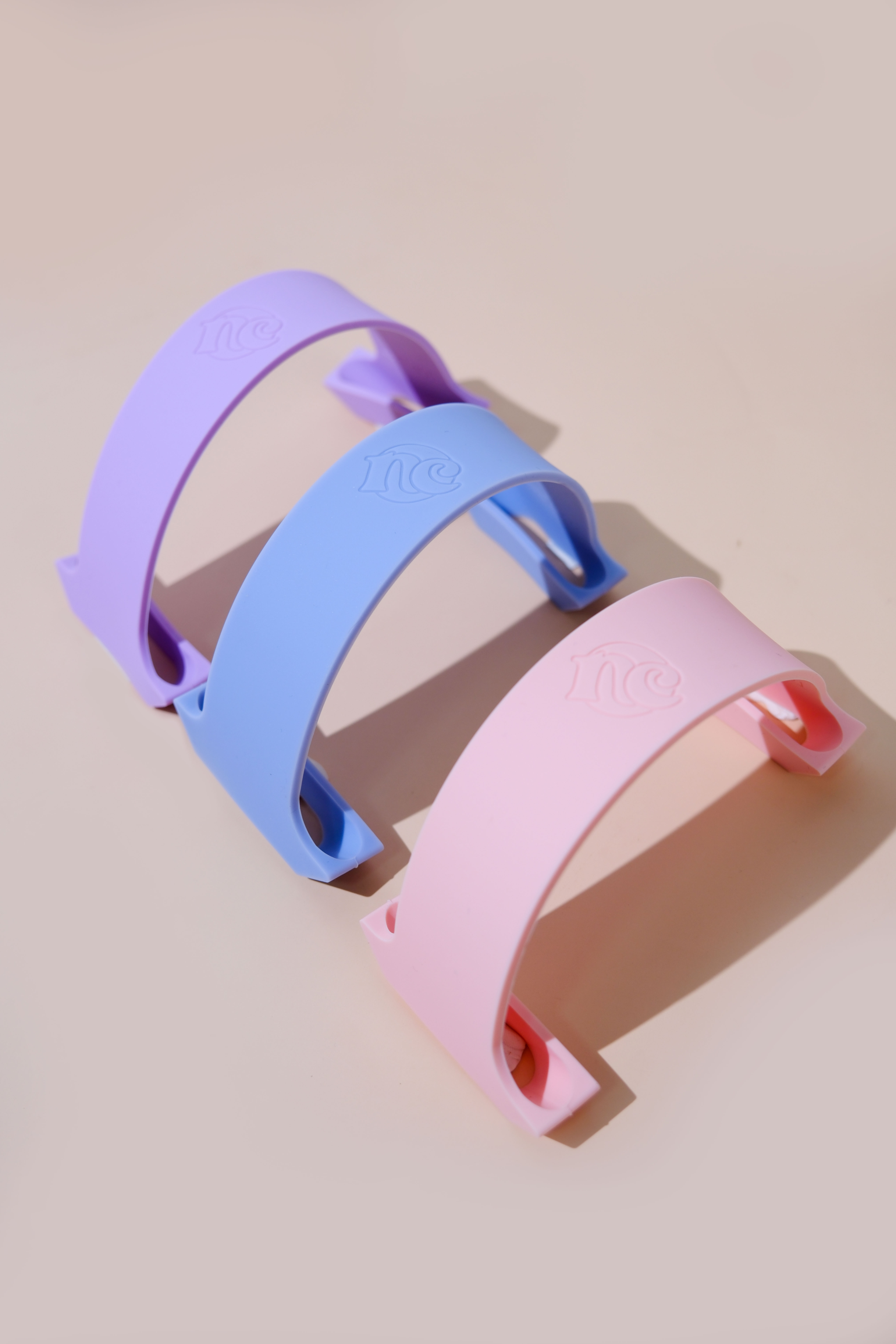 Lilac, periwinkle, and blush straps arranged on a studio set