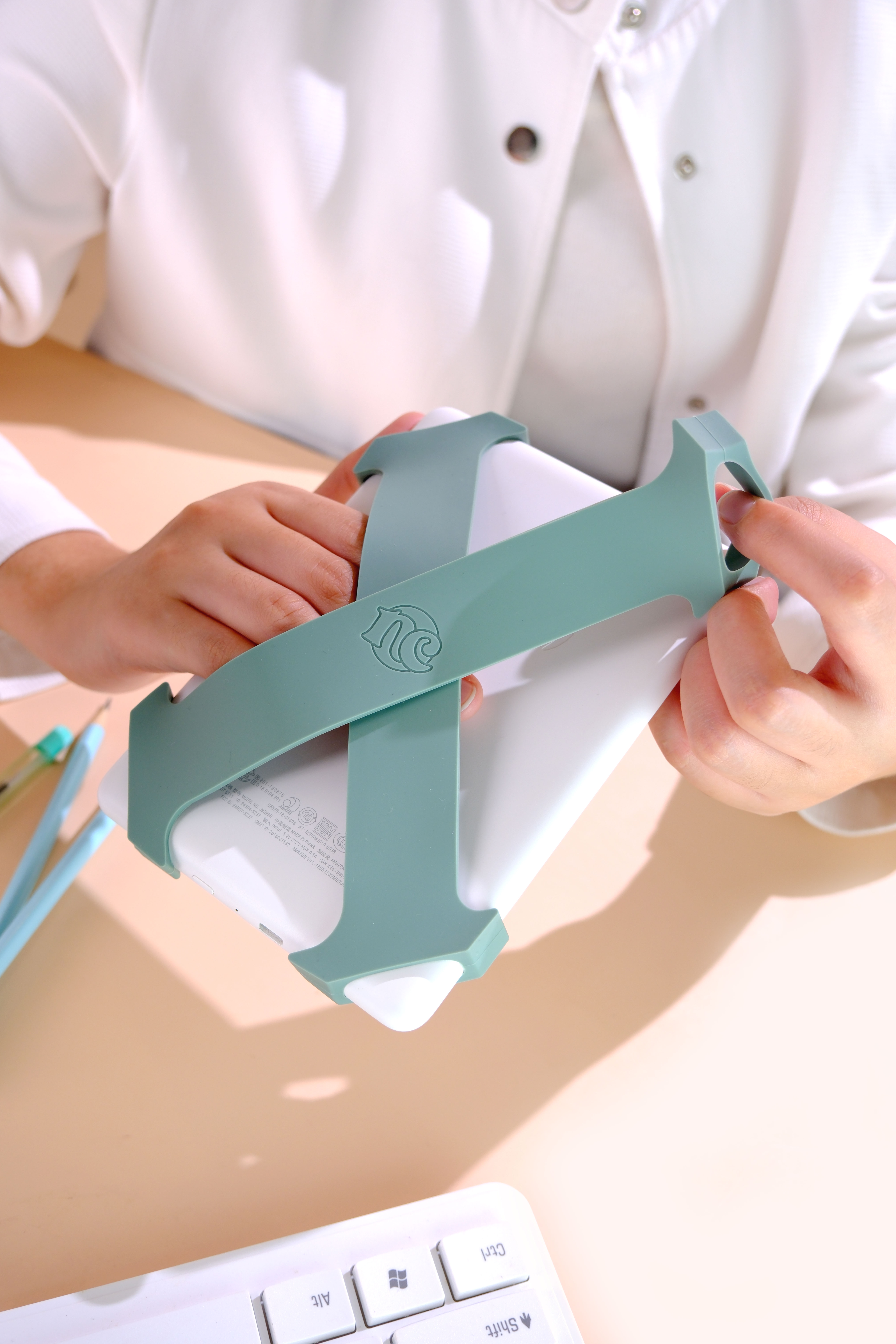 Sage Everstraps being fitted onto an e-reader
