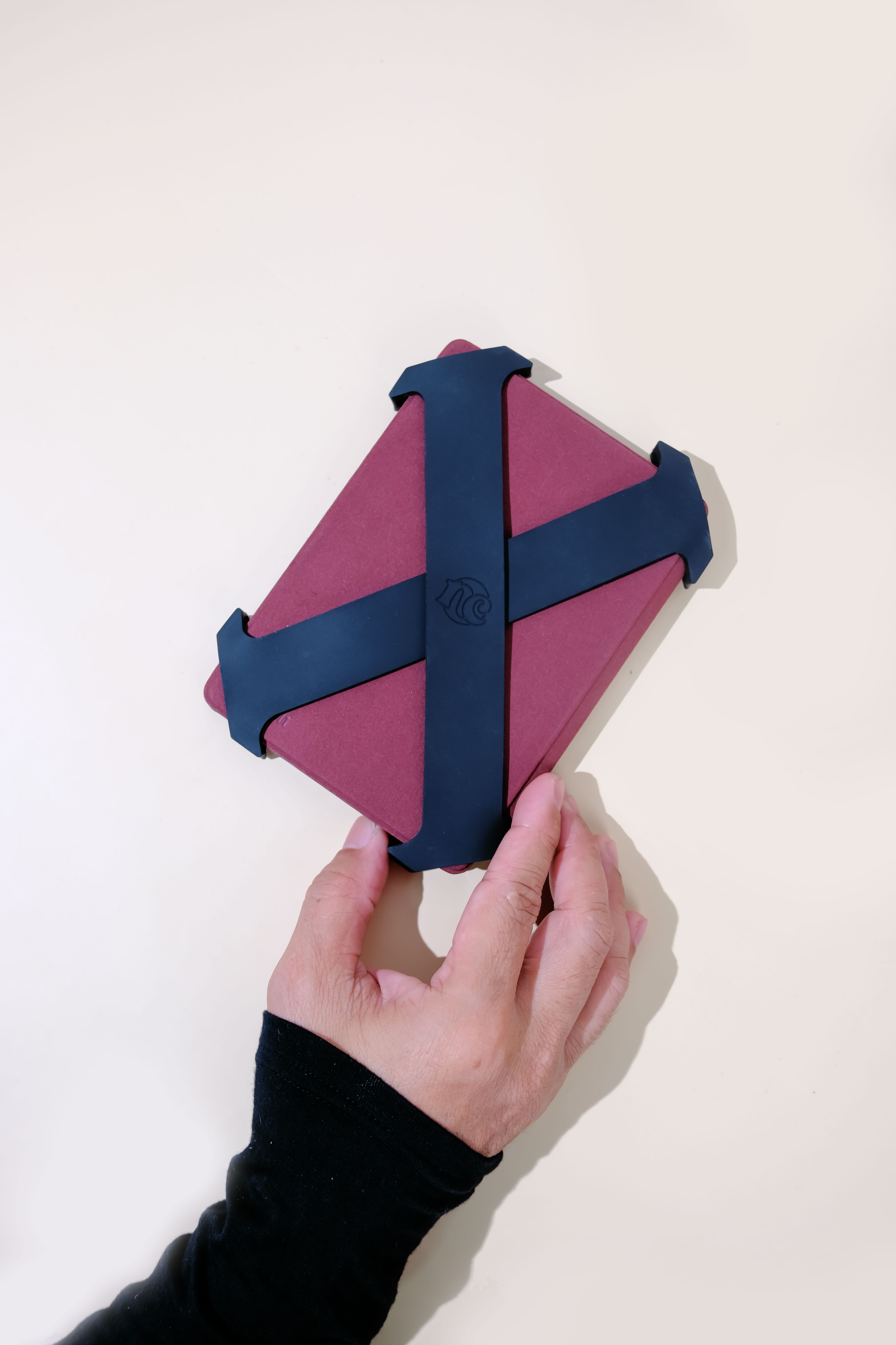 Midnight straps fitted to a burgundy e-reader